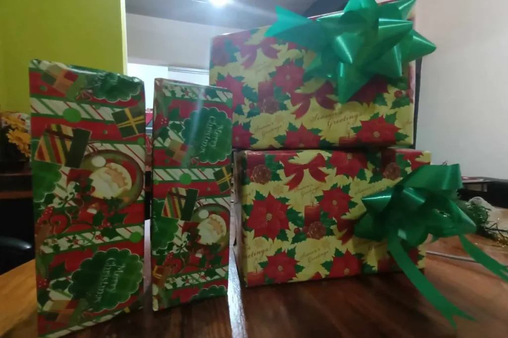 Φωτογραφία με τυλιγμένα χριστουγεννιάτικα δώρα με πράσινες κορδέλες πάνω σε τραπέζι